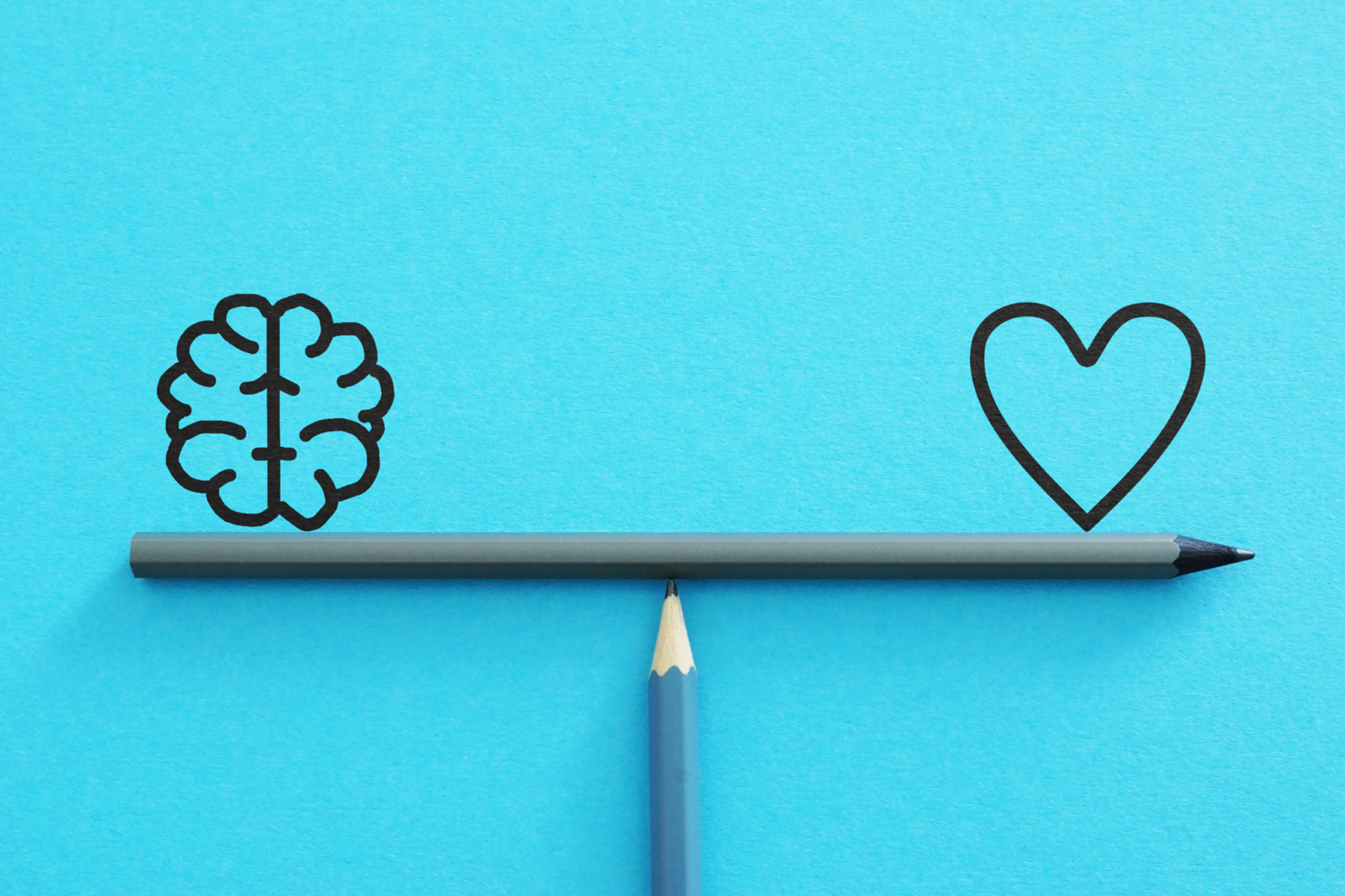 Pencils balancing a brain and a heart