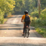 Picture of child riding bike on rural road.