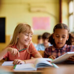 Student and classmate working together in class